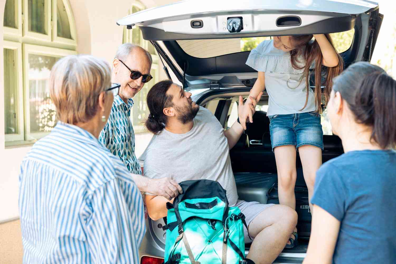 Family loading luggage into a spacious vehicle for a stress-free airport taxi shuttle service.